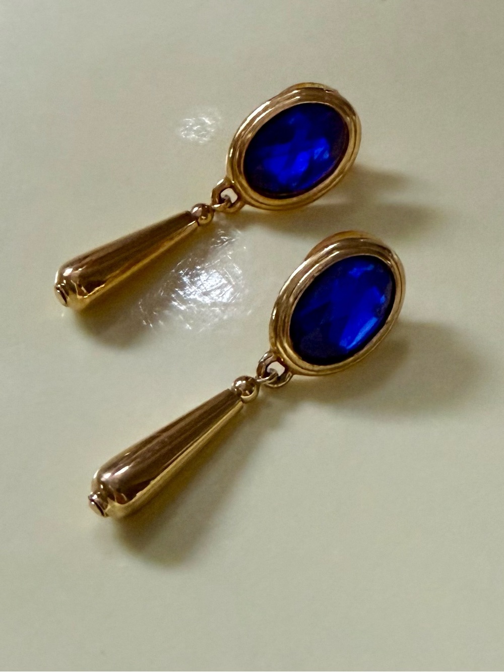 Elegant Gold Tone Earrings with Deep Blue Oval Stones